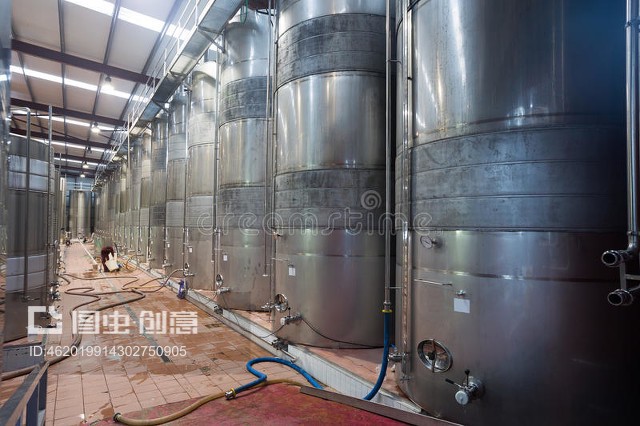 含發酵葡萄酒的不銹鋼蓄水池Stainless cisterns with fermenting wine in fabric